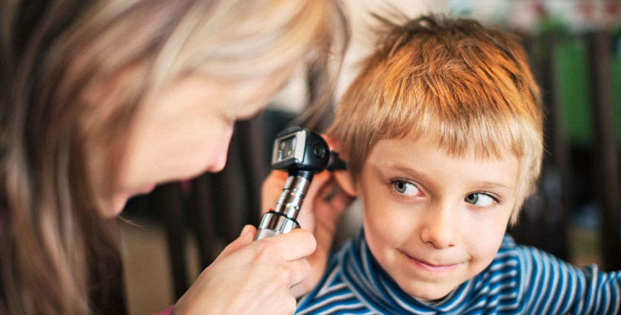A child being examined with an otoscope
