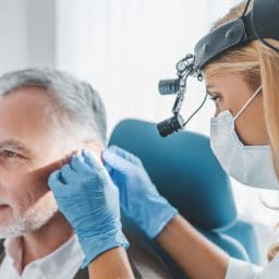 Man getting his ears checked by a doctor.
