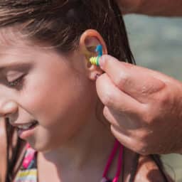 Young girl wearing earplugs