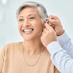 Woman with hearing aids smiles